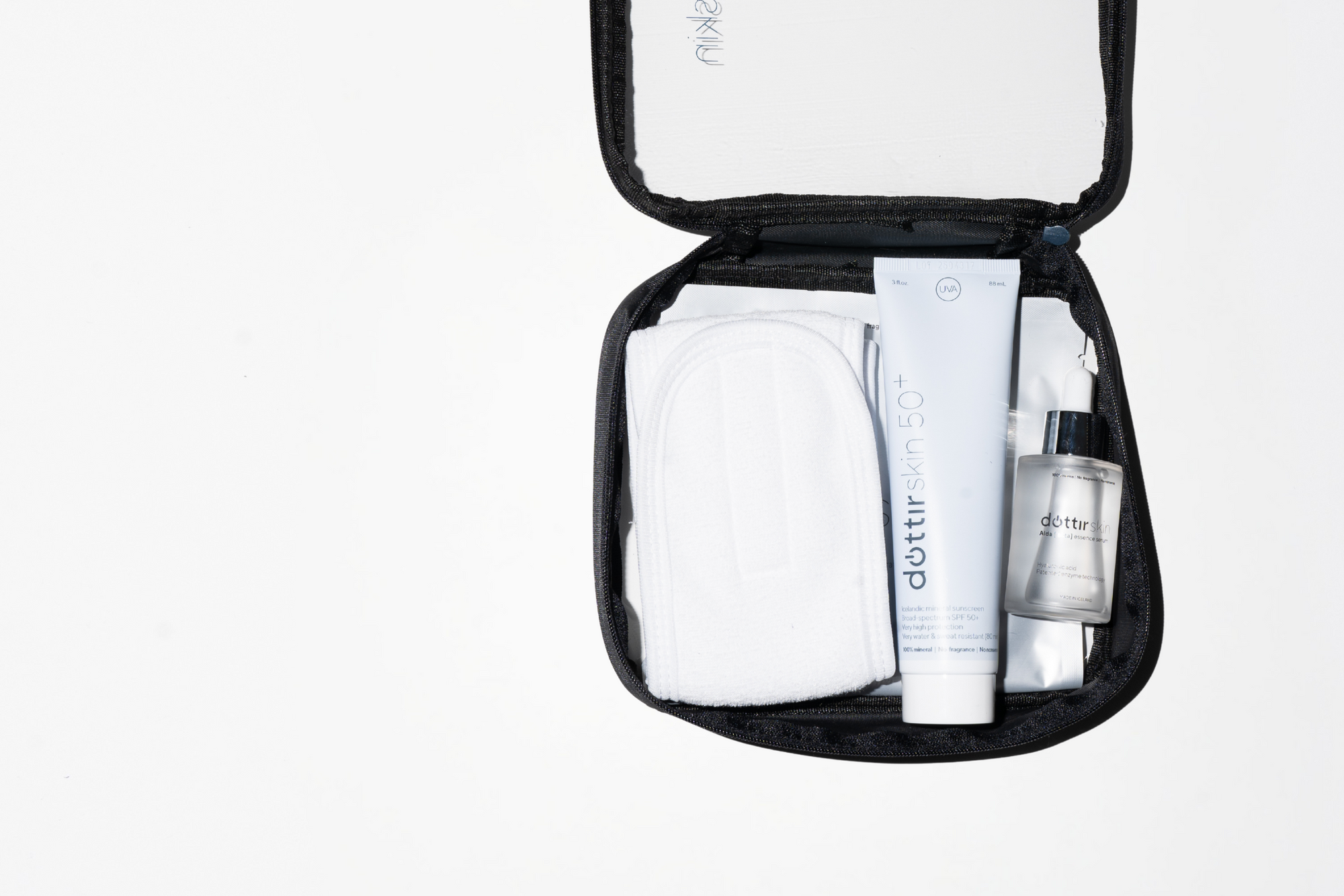 Value set of all Dóttir Skin products (1x Dóttir Skin Mineral Broad-spectrum SPF50+, 1x Alda essence serum, 2x Ljóma dew mask) in a Dóttir Skin toiletry bag, with a skincare headband.